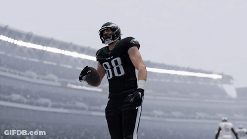 A Football Player With The Number 88 On His Jersey Holds A Ball GIF