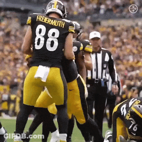 A Football Player With The Number 88 On His Jersey Is Being Tackled By Another Player . GIF