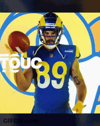 A Football Player With The Number 89 On His Jersey Holds A Football GIF