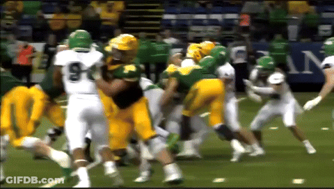 A Football Player With The Number 9 On His Jersey Is Being Tackled GIF