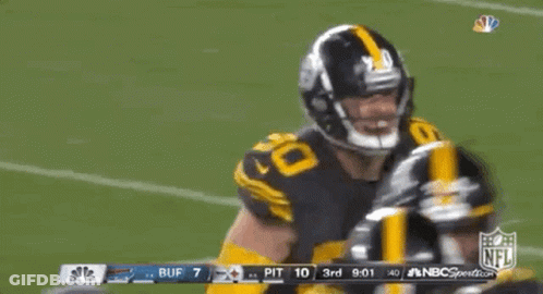 A Football Player With The Number 90 On His Jersey Is Dancing On The Field GIF