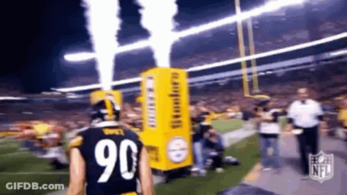 A Football Player With The Number 90 On His Jersey Is Walking On The Field GIF
