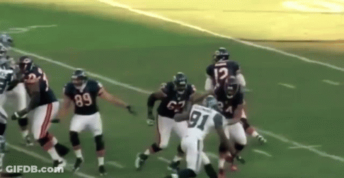 A Football Player With The Number 91 On His Jersey Is Being Tackled By Another Player GIF