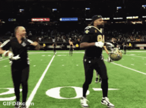 A Football Player With The Number 91 On His Jersey Is Dancing GIF