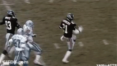A Football Player With The Number 93 On His Back Is Jumping In The Air GIF