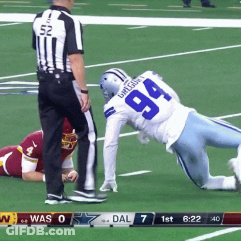 A Football Player With The Number 94 On His Jersey Is Being Tackled By A Referee GIF