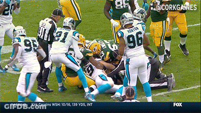 A Football Player With The Number 96 On His Back Is Being Tackled GIF