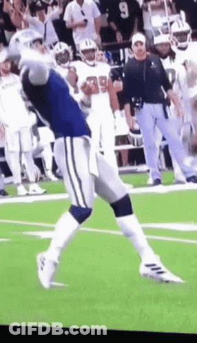 A Football Player With The Number 99 On His Jersey Is Running On The Field GIF