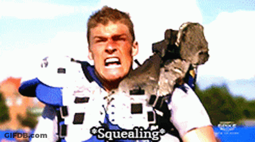 A Football Player With The Word Squealing Written On His Shirt GIF