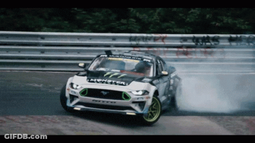 A Ford Mustang Drifting On A Race Track GIF