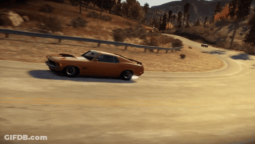 A Ford Mustang Is Driving Down A Road With Mountains In The Background GIF