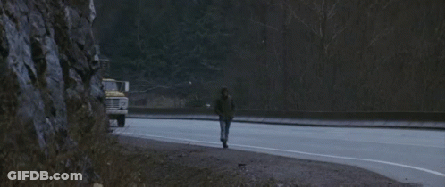 A Ford Truck Is Driving Down The Road Next To A Van GIF