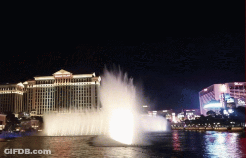 A Fountain In Front Of A Building That Says ' Bellagio ' On It GIF