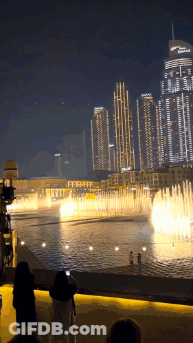 A Fountain In Front Of A Building That Says Dubai On It GIF