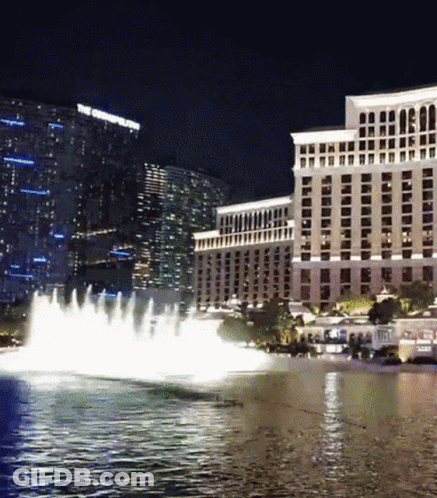 A Fountain In Front Of A Large Building That Says The Cosmopolitan GIF