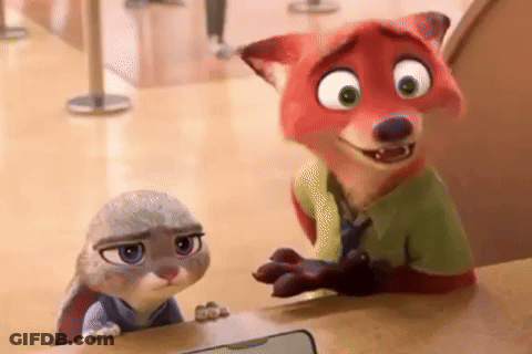 A Fox And A Rabbit From Zootopia Are Standing Next To Each Other On A Counter . GIF