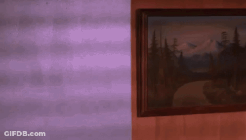 A Framed Painting Of A Mountain Landscape On A Purple Wall GIF
