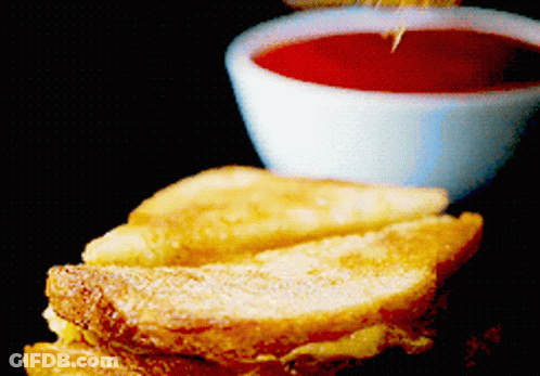 A French Toast Sandwich Next To A Small Bowl Of Sauce GIF