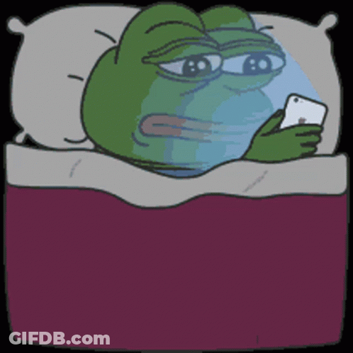 A Frog Is Laying In Bed Looking At A Phone GIF