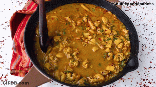 A Frying Pan Filled With Chicken Curry With The Hashtag Chili Pepper Madness On The Bottom GIF