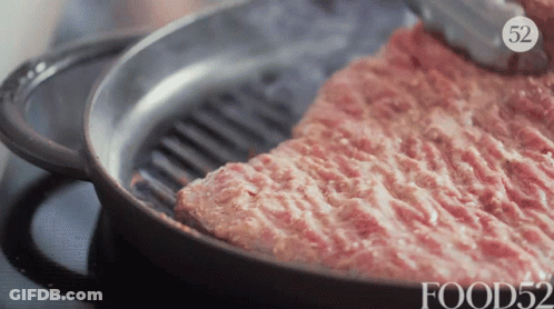 A Frying Pan Filled With Meat And The Number 52 On The Bottom GIF