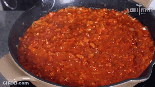 A Frying Pan Filled With Tomato Sauce With The Words Chili Pepper On The Bottom GIF