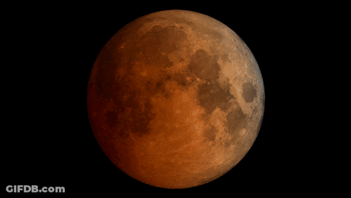 A Full Moon Is Shown In A Black Background GIF