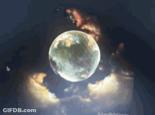 A Full Moon Is Surrounded By Clouds In The Sky GIF