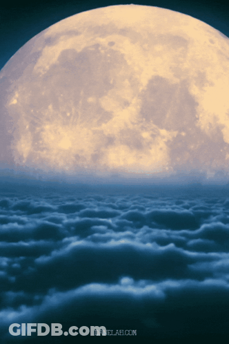 A Full Moon Is Visible Over A Cloudy Sky GIF