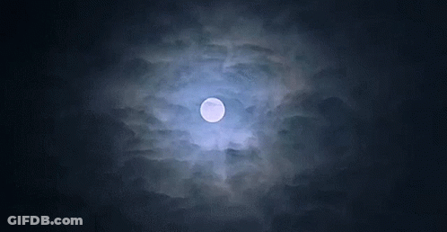 A Full Moon Is Visible Through The Clouds At Night GIF