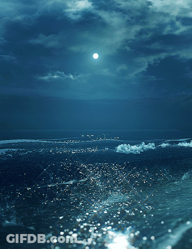 A Full Moon Shines Brightly Over A Body Of Water GIF