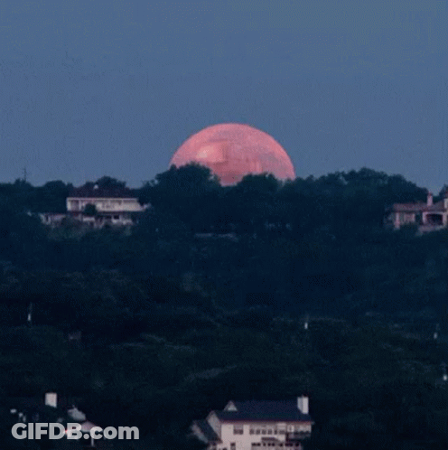 A Full Moon With A Cartoon Face On It GIF