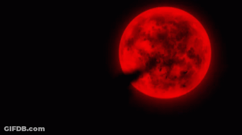 A Full Red Moon Is Shining Brightly In The Dark GIF