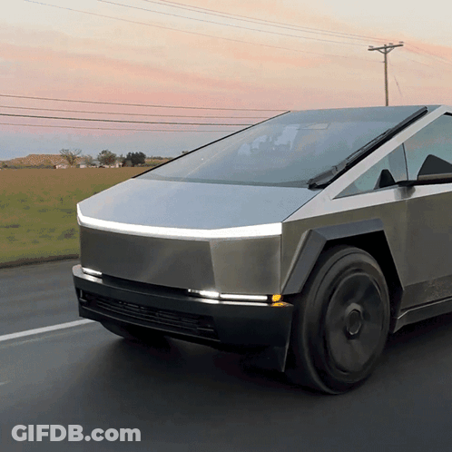 A Futuristic Car Is Driving Down A Road GIF