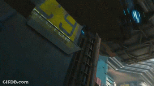 A Futuristic City With A Sign That Says St. On It GIF