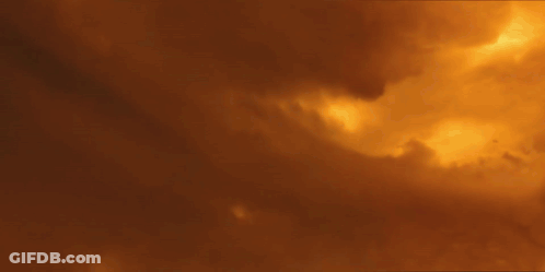 A Futuristic Space Ship Is Flying Over Mountains GIF