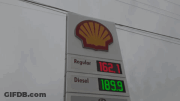 A Gas Station With A Sign That Says Regular Diesel And Bmo On It GIF