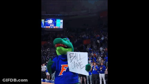 A Gator Mascot Is Holding A White Board That Says Ball Game GIF