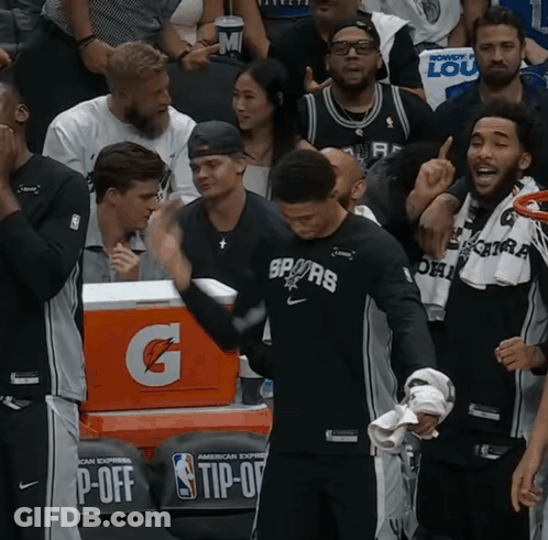 A Gatorade Cooler Sits Behind A Group Of Basketball Players GIF