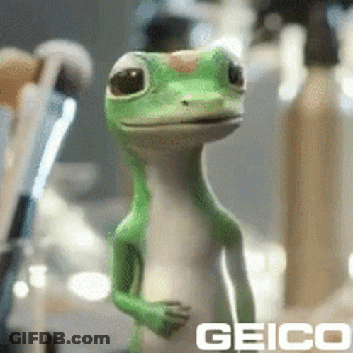 A Geico Lizard Is Standing In Front Of A Mirror GIF