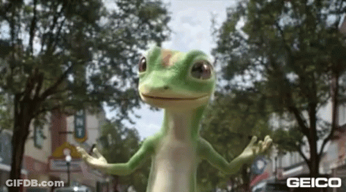 A Geico Lizard Is Standing On A Street With Its Arms Outstretched . GIF