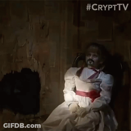 A Ghost Doll Is Sitting In A Chair In A Dark Room . GIF