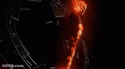 A Ghost Rider Is Flying Through The Air With A Flame Trail Behind Him GIF