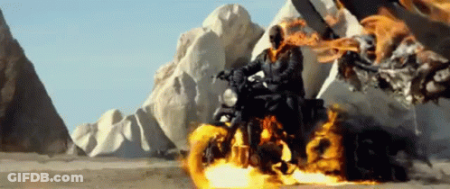 A Ghost Rider Is Riding A Motorcycle On A Desert Road . GIF