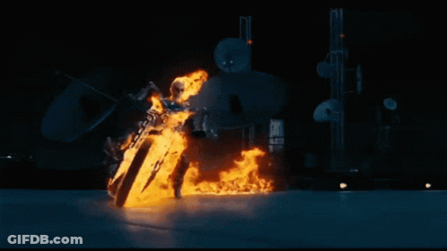 A Ghost Rider Is Riding A Motorcycle Through The Air With Flames Coming Out Of It . GIF