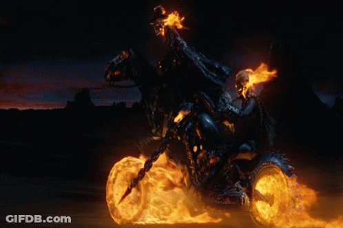 A Ghost Rider Is Riding A Motorcycle With Flames Coming Out Of The Wheels GIF