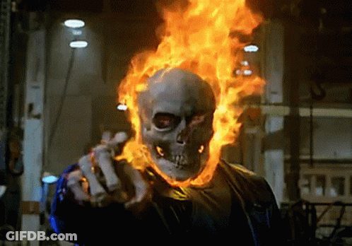 A Ghost Rider With Flames Coming Out Of His Head Is Pointing GIF