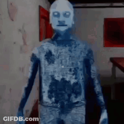A Ghost With A White Face Is Standing In A Room In A Video Game . GIF