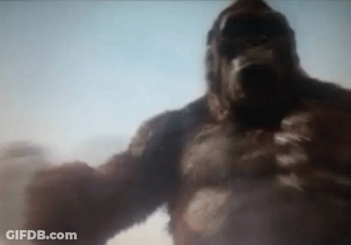 A Giant Gorilla Is Standing In The Middle Of The Desert . GIF