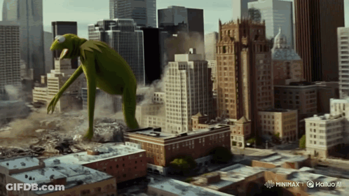 A Giant Kermit The Frog Is Standing In A City GIF